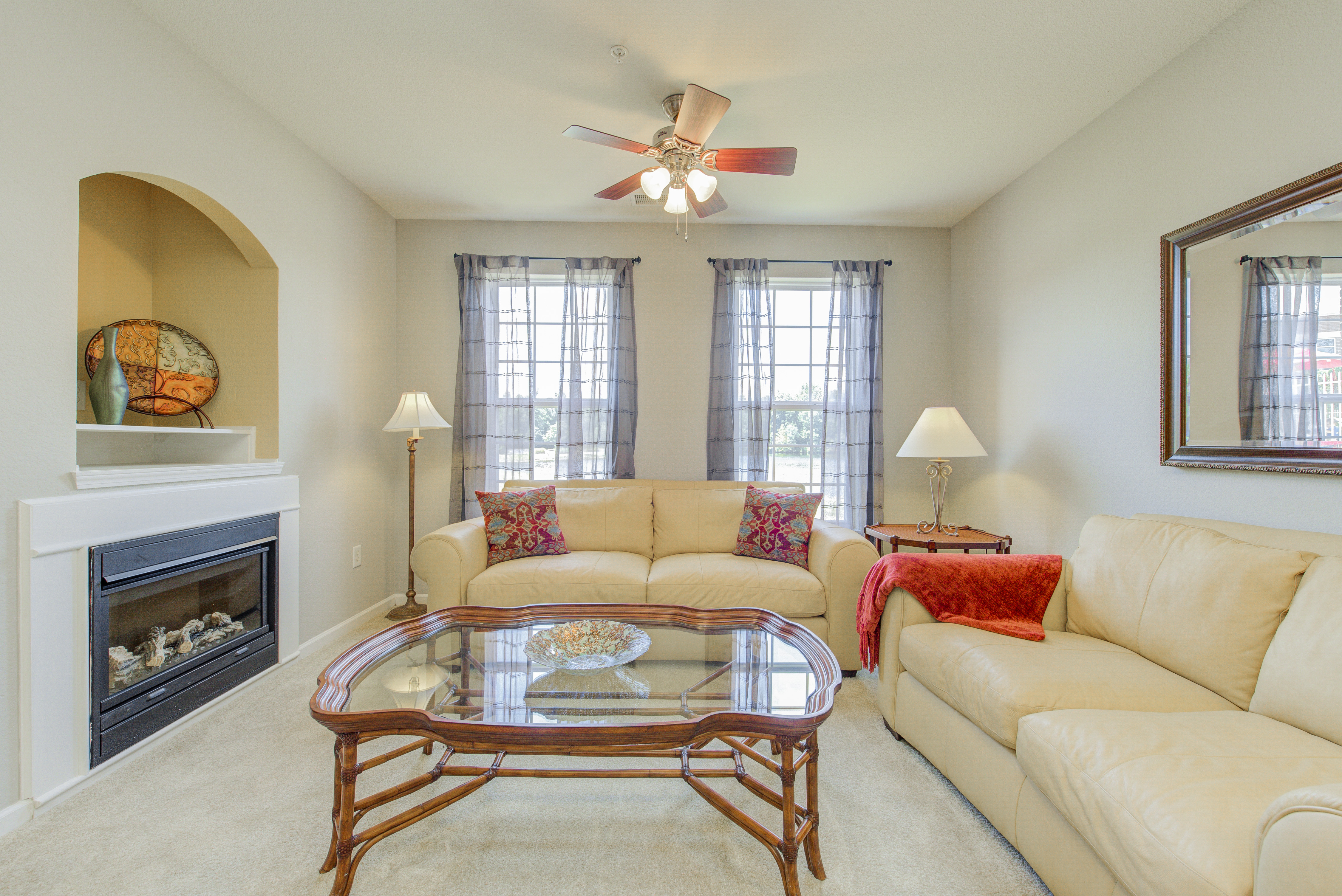 Living room in neutral colors with fireplace and matching furniture